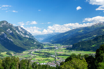 Fototapeta na wymiar Panoramic view of countryside, green alpine meadows and mountains
