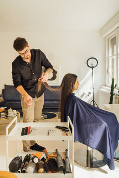 Hairdresser Cutting Client's Hair 