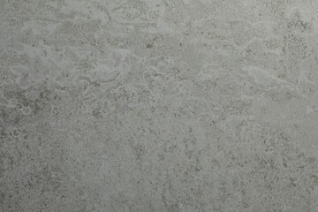 Texture of light grey stone surface as background, closeup