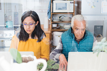 Grandfather learning how to use a notebook
