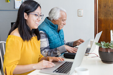 Happy senior citizen learning how to use a computer