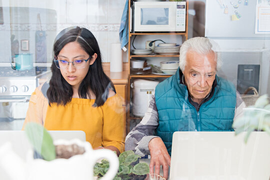 Grandfather learning how to use a notebook