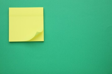 Empty notes on green background, top view. Space for text