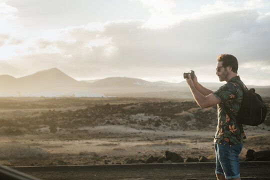 Traveler Man Taking A Photo With Camera