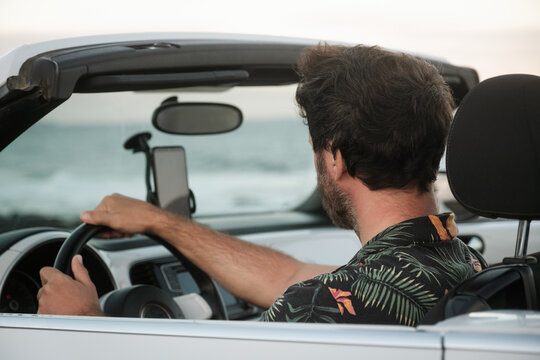 Anonymous man driving and looking phone gps