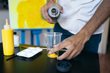 Artist preparing his materials to paint a picture on canvas