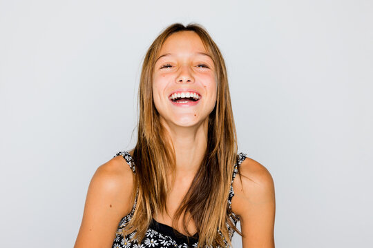Happy teenager posing in studio and looking at camera