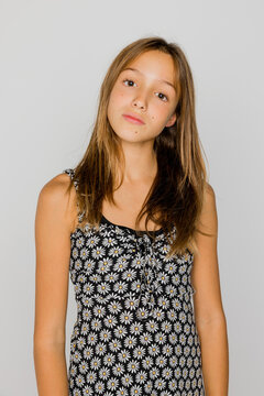 Serious teenager posing in studio and looking at camera