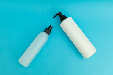 Hair spray in blue plastic bottle on blue background, monochrome