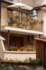 Exterior of beautiful residential building with balconies and flowers