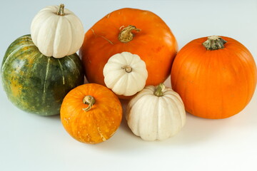 Ripe pumpkins of different colors and sizes on a white surface. Step 1. Step-by-step instructions. Candied pumpkin recipe