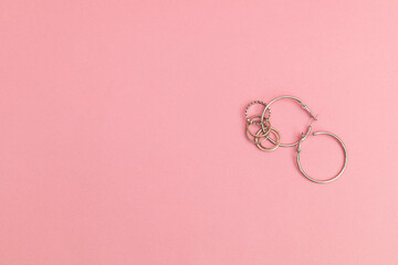 Silver jewelry on a pink background