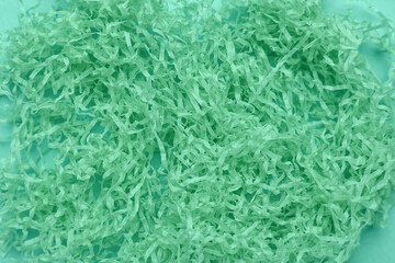 Heap of shredded paper on mint background, closeup