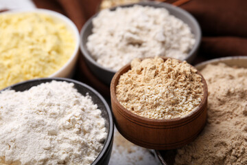 Bowls with different types of flour, closeup