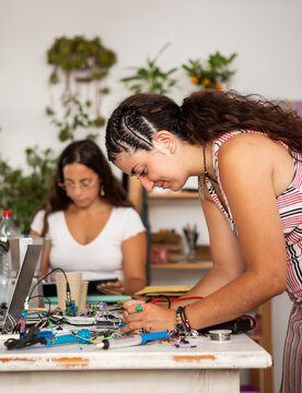 A woman working on an engineering component. 