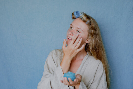 girl applying scrub on her face