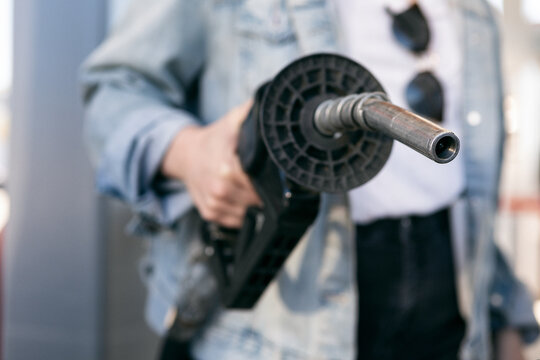 Woman Holding Gas Pump Nozzle