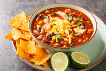 Tasty chicken taco soup full of tender chicken, sweet corn, black beans, fire-roasted tomatoes, and...