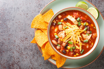 Tasty chicken taco soup full of tender chicken, sweet corn, black beans, fire-roasted tomatoes, and...