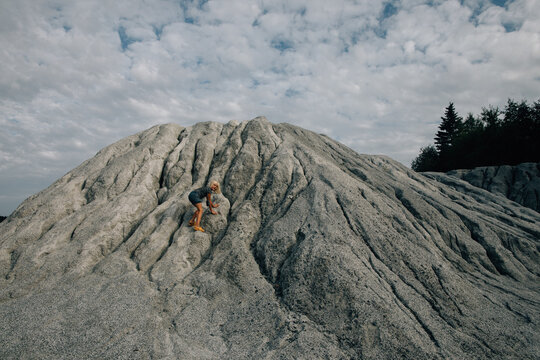 Child slides off the marble mound