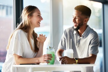 Couple, drink and happy with talking, date and enjoy in shop, cafe or store with smile, happy and romance. Interracial man, woman or friends in funny conversation, communication and bonding together