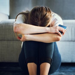 Sad, depression and woman with phone in living room home after break up message, cyber bullying...