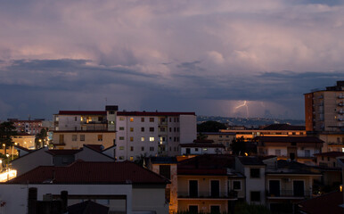 panoramica city skyline of Aversa in bad weather with clouds and thunder lightning