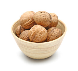 Bowl of fresh walnuts on white background