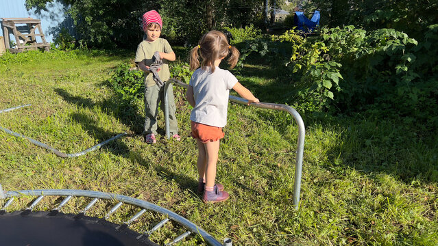 Kids helping with fixing trampoline
