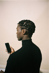 Film photo of a portrait of a black man in a black turtleneck