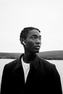 Film photo portrait of a man wearing AirPods headphones