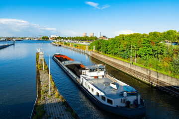Cargo ship loaded with coal leaving the sluice in Maasbracht, Netherlands
