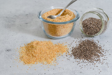 Flaxseed meal and Chia seeds close up in a glass bowls