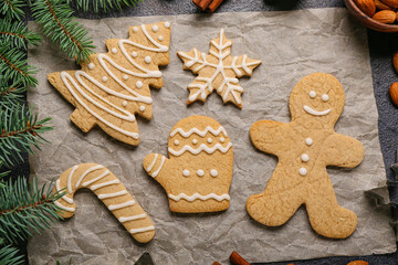 Sheet of baking paper with sweet Christmas cookies on table, closeup