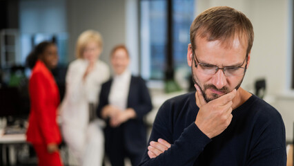 A middle-aged man is upset because of the ridicule of his female colleagues. Discrimination against...
