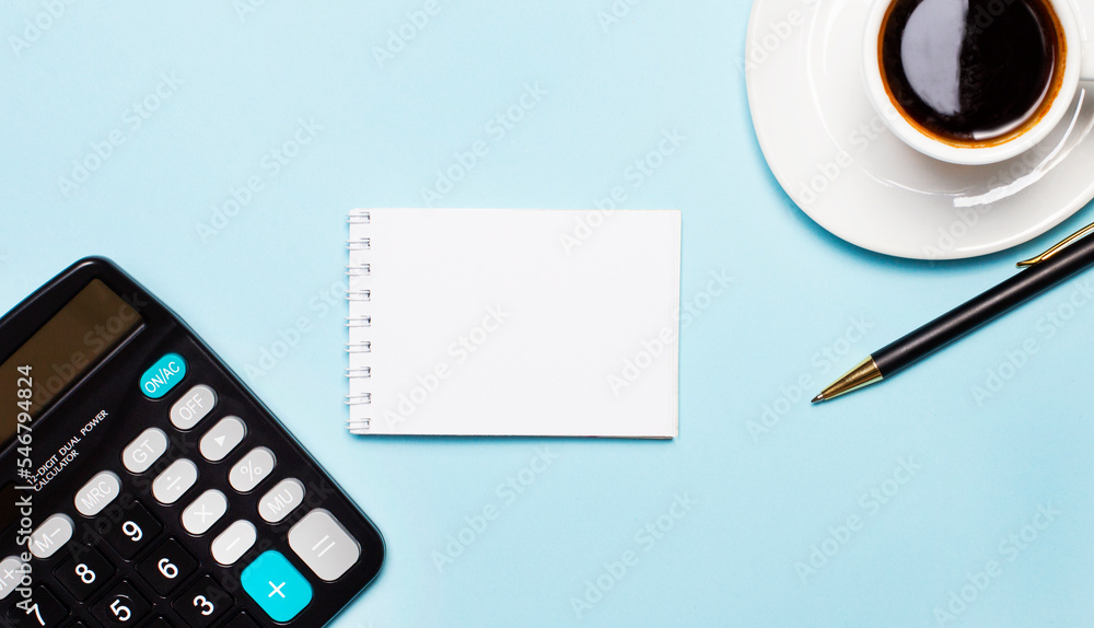 Aufkleber office table with a cup of coffee, a calculator, a pen and a blank notepad with space to insert text