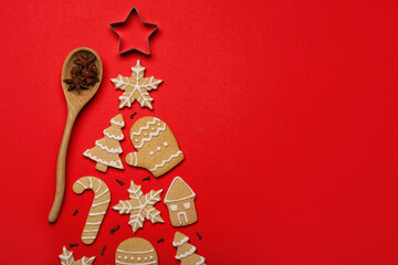Christmas tree made of tasty cookies, cutter and spices on red background, closeup