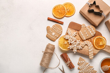 Composition with tasty Christmas cookies,gift and orange slices on light background