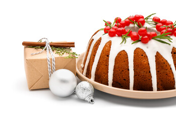 Delicious Christmas cake with cranberry, gift and balls on white background, closeup