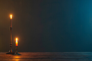 burning candles in vintage candlesticks on dark background
