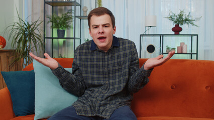 What. Why. Teenager man raising hands in indignant expression, asking reason of failure,...