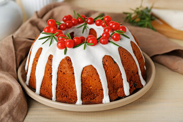 Delicious Christmas cake with cranberry on wooden table, closeup