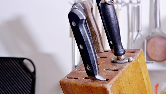 Small Knife Pulled Out Of The Wood Stand Knife Holder In The Kitchen