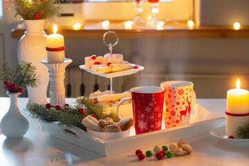 christmas decor and red cups with hot drink on kitchen