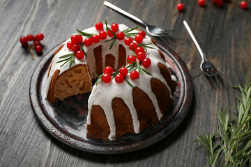 Plate with delicious Christmas cake on dark wooden background