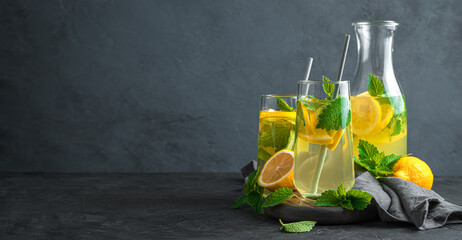 Lemonade with mint on a dark background. Healthy drinks. Side view, copy space.