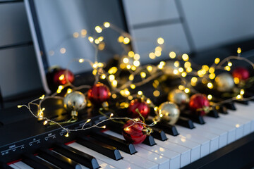 Piano keyboard with Christmas garland close up