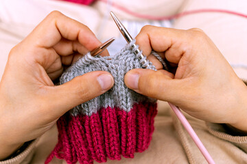 Close-up of Girl with knitting needles. Handmade concept.