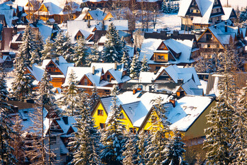 snow-covered village houses of Koscielisko Valley. Poland