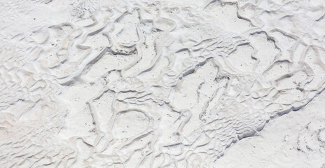 White volcanic limestone rock as background.